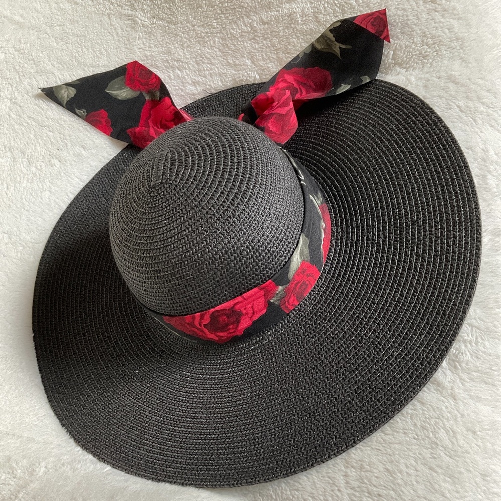 Black wide brim hat with attached floral ribbon.